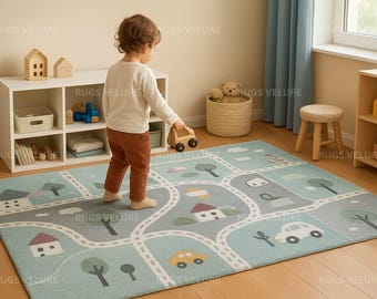 May include: A rectangular, light blue children's play rug with a road map design. The rug features roads, houses, trees, and cars in various colors. A child is holding a wooden toy car. The rug measures approximately 60 x 80 inches.
