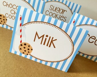 May include: Four blue and white striped table cards with brown polka dots and a brown oval border. The cards have the text "Chocolate Chip Cookies", "Sugar Cookies", "Milk", and "Ice Cream" printed on them.