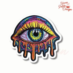 May include: Embroidered patch featuring a colorful, stylized eye with dripping details. The eye has a blue iris, yellow center, and pink veins, with orange and yellow drips. The patch has a white border and the text "Uzura Patch Design".