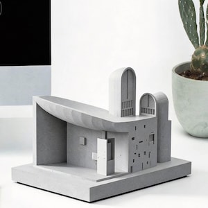 May include: A set of three ceramic mugs with a speckled, matte finish. The mugs are in shades of cream, light brown, and dark brown. Each mug has a simple, minimalist design, perfect for coffee or tea.