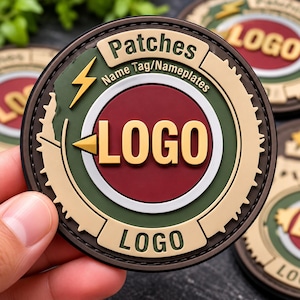 May include: A circular PVC patch featuring a dark red center with the word LOGO in gold. The border is olive green and beige with the text Patches, Name Tag/Nameplates, and LOGO. A gold lightning bolt icon is on the left side of the patch.