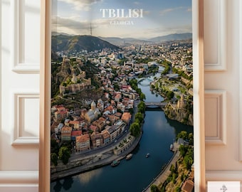 May include: Framed print of Tbilisi, Georgia, featuring a cityscape with a river, bridges, and buildings. The print includes the text "TBILISI GEORGIA" at the top. The image is in a wooden frame.