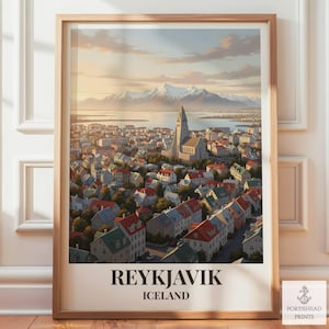 May include: A framed art print featuring a cityscape of Reykjavik, Iceland, with a prominent church, colourful houses, and snow-capped mountains in the background. The text REYKJAVIK ICELAND is printed in black at the bottom of the vertical poster.