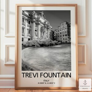 May include: Monochrome framed print of the Trevi Fountain in Rome, Italy. The image shows the famous baroque fountain with water flowing into a pool. The print includes the text "TREVI FOUNTAIN" and coordinates.