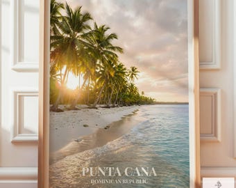 May include: A framed wall art print featuring a tropical beach scene in Punta Cana, Dominican Republic. The image displays a sandy shoreline with tall palm trees, calm ocean water, and a sunset sky. The text reads Punta Cana Dominican Republic.