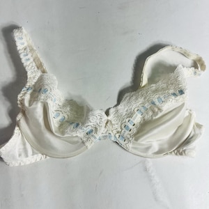 May include: A white ceramic mug with a black handle and the text "But First, Coffee" in a black, handwritten-style font. The mug is likely 4 inches tall and holds approximately 12 ounces of liquid.