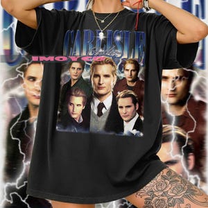 May include: Black graphic t-shirt featuring a collage of images and the text "CARLISLE Cullen" in a blue and white font. The shirt has a vintage style and a crew neck.
