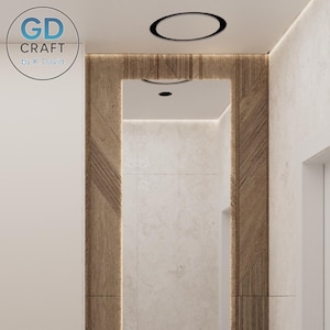 Op de afbeelding: Interieurontwerp met een houten paneel met een geometrisch patroon, dat een spiegel omlijst. Het plafond heeft een inbouwverlichting en een cirkelvormig zwart accent. De muur is lichtbeige van kleur. Het logo "GD CRAFT by K. David" staat linksboven.