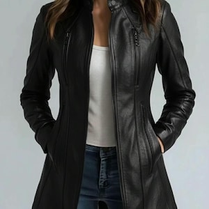 May include: Black leather jacket with a stand-up collar, multiple zippered pockets, and a tailored fit. The jacket has a full-length zipper closure and a sleek, modern design. The jacket is a mid-length coat.