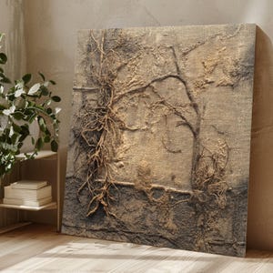 May include: Textured canvas art featuring a tree-like design with intricate root and branch details. The artwork uses a neutral color palette of beige, brown, and gray, creating a natural and earthy aesthetic. The piece is displayed on a wooden floor.