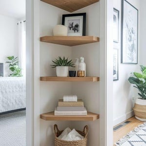 May include: A corner shelving unit with four wooden shelves. The shelves display plants, books, decorative items, and a woven basket. The shelves are mounted on a white wall, creating a functional and stylish storage solution.