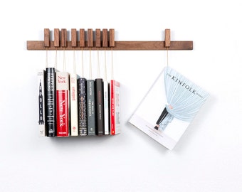 Custom made wooden book rack / bookshelf in Walnut. Pins also work as bookmarks. Bookcase