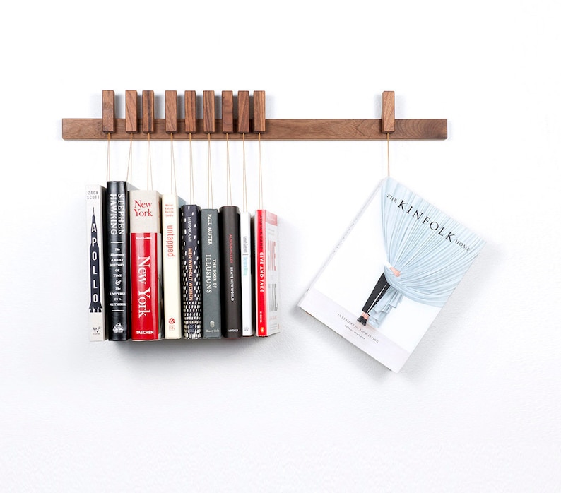 Custom made wooden book rack / bookshelf in Walnut. Pins also work as bookmarks. Bookcase image 1