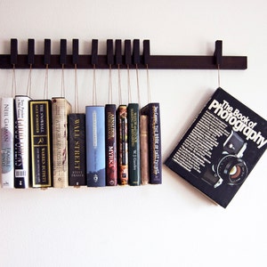 Book rack in fumed oak. Hanging bookshelf. Book hanger in dark wood. Pins work as bookmarks. Bookcasw. Floating bookshelf. Unique library. image 1