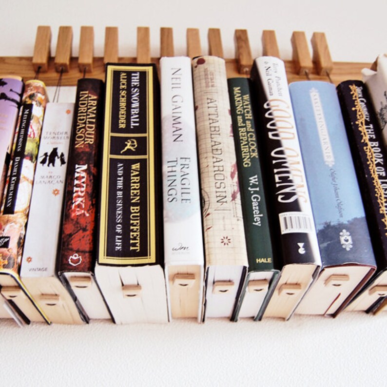 Custom made wooden book rack / bookshelf in Oak. The pins are image 4