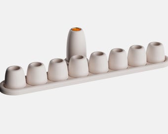 Pebble Menorah. A 3D-printed menorah inspired by smooth river pebbles.