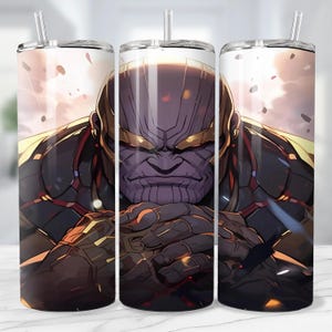 May include: A set of three stainless steel tumblers featuring a detailed illustration of Thanos from the Marvel comics. The design showcases Thanos's face and armor in shades of purple, gold, and black, with a straw and lid.