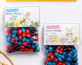 May include: Two clear bags filled with red, blue, and black jelly beans, labeled "Easter Bunny Poop." The bags are topped with a decorative card featuring a bunny illustration. A wicker basket with pastel Easter eggs is in the corner.