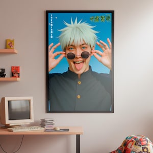 May include: A framed poster featuring a person with light blue hair and round sunglasses, sticking out their tongue. The poster has Japanese text and is set against a blue background. The room includes a beanbag chair, a desk with a computer, and decorative shelves.