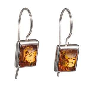 May include: A pair of silver earrings featuring rectangular amber stones. The amber stones have a warm, golden-brown hue with visible inclusions. The earrings have a simple, elegant design with a hook closure.