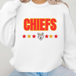 May include: White sweatshirt with red and gold lettering that says "CHIEFS" and a cartoon wolf mascot with five gold stars.