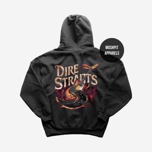 May include: Dark gray hoodie featuring a graphic of a guitar with a road design and the words "Dire Straits" in a distressed font. The design includes flames and a black circle with the text "Moshpit Apparels".