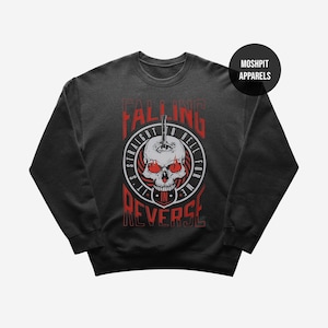 May include: Dark grey sweatshirt with a graphic design. It features a skull, the text "FALLING IN REVERSE", and the phrase "STRAIGHT TO HELL FOR ME". The design is in red and white.