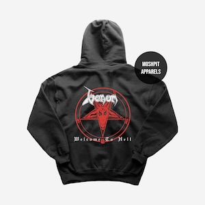 May include: Black hooded sweatshirt with a red and white graphic. The graphic features a red pentagram with a goat head, the band name "Venom", and the text "Welcome To Hell". The sweatshirt has a drawstring hood.