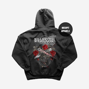 May include: Dark gray hooded sweatshirt featuring a graphic design on the back. The design includes the text "KILLSWITCH ENGAGE" above a graphic of roses and a sword. The brand name "MOSHPIT APPARELS" is also visible.