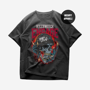 May include: Dark gray t-shirt featuring a skull graphic with the text "KILLSWITCH ENGAGE" in red. The skull is wearing a bandana with the words "Disarm the Descent". The shirt has a crew neck and short sleeves.