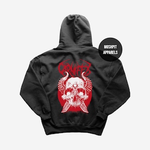 May include: Dark grey hoodie with a red and white skull graphic, horns, knives, and the word "CARNIFEX". The hoodie includes a hood and a round logo that says "MOSHPIT APPARELS".