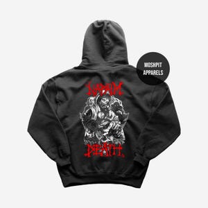 May include: Black hooded sweatshirt with a graphic design on the back. The design features a detailed illustration in white and red, including the words "NAPALM DEATH" in red, and a circular logo that says "MOSHPIT APPARELS".