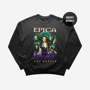 May include: Black sweatshirt featuring the band name "EPICA" above a graphic of a woman and several figures in a purple and green design. The text "THE BATTLE" is below the graphic. The brand name "MOSHPIT APPARELS" is in a black circle.