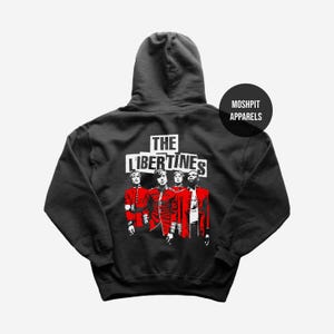 May include: Black hooded sweatshirt featuring a graphic of the band The Libertines. The design includes the band's name in white block letters above a stylized image of the band members in red and white. The sweatshirt also has the text "MOSHPIT APPARELS" in a black circle.