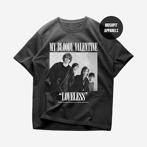 May include: Dark grey t-shirt with a black and white image of the band My Bloody Valentine. The text "MY BLOODY VALENTINE" is above the image, and "LOVELESS" is below. The shirt also has the text "THEY INVENTED IT. ALL YOU HAVE TO DO IS LISTEN TO IT."