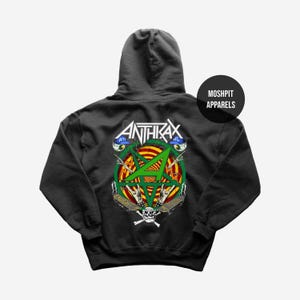 May include: Dark grey hooded sweatshirt with a graphic design featuring the word "ANTHRAX" above a green star and skull. The design includes a circle with red, yellow, and green accents. The sweatshirt has a hood and a front pocket.