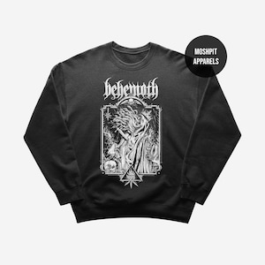 May include: Black sweatshirt with a white graphic featuring the word "Behemoth" above a detailed illustration of figures and symbols. The design includes a skull, stars, and a triangular emblem. The brand name "Moshpit Apparels" is in a black circle.