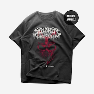 May include: Dark gray t-shirt featuring a red and white graphic design. The design includes the text "Slaughter to Prevail" in a stylized font, along with a red skull-like image and the text "Misery Sermon".
