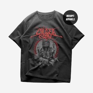 Puede incluir: Camiseta gris oscuro con un gráfico rojo y negro de una figura con cuernos y el texto "Chelsea Grin". La camiseta también tiene un logotipo circular que dice "Moshpit Apparels".