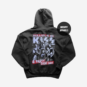 May include: Dark gray hooded sweatshirt featuring a graphic of the band KISS. The design includes the band's logo and the text "ROCK & ROLL ALL NITE" and "& PARTY EVERY DAY!" in red and white. The sweatshirt has a drawstring hood and a kangaroo pocket.