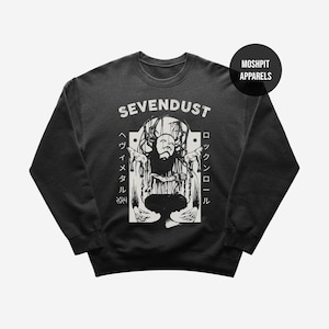 May include: Dark gray sweatshirt featuring a distressed white graphic with the band name "SEVENDUST" and a stylized illustration. The design includes Japanese text and the words "Heavy Metal" and "Rock and Roll". The sweatshirt has a crew neck and long sleeves.