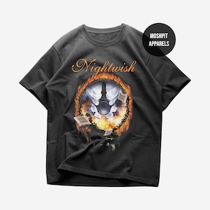 May include: Dark gray t-shirt featuring the band name "Nightwish" in an orange, stylized font. The graphic depicts a circular design with a moon, flames, and open books. The shirt includes a "Moshpit Apparels" logo.