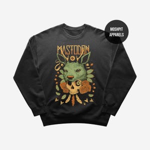 May include: Black crewneck sweatshirt with a graphic design featuring a green kangaroo head, a skull, and the word "MASTODON" in gold lettering. The design includes orange roses and feathers. The brand name "MOSHPIT APPARELS" is also visible.