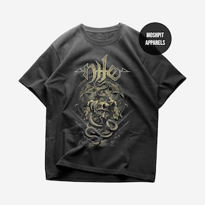 May include: Dark gray t-shirt featuring a detailed gold graphic of a skull, snakes, and other imagery. The word "NHE" is displayed in a stylized font above the graphic. A black circle with the text "MOSHPIT APPARELS" is in the upper right corner.