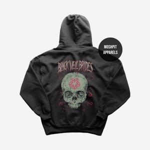May include: Dark gray hoodie featuring a skull graphic with a red floral design and the text "BLACK VEIL BRIDES". The hoodie also has the text "MOSHPIT APPARELS" on the upper right side.