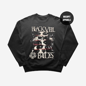 May include: Dark gray sweatshirt featuring the band name "Black Veil Brides" in a distressed font above a graphic of eyes. The band's logo is at the bottom. A black circle with "Moshpit Apparels" is in the upper right.