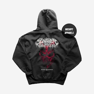 May include: Dark gray hoodie featuring a red and white graphic design on the back. The design includes the text "Slaughter to Prevail" above a red skull image, with "Misery Sermon" below. A black circle with "Moshpit Apparels" is on the right.