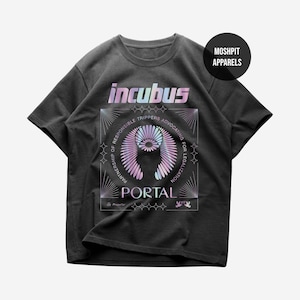 May include: Dark grey t-shirt featuring the word "incubus" in a holographic font. Below is a geometric design with the word "portal" and the text "Partnership of Responsible Trippers Advocating for Legalization."