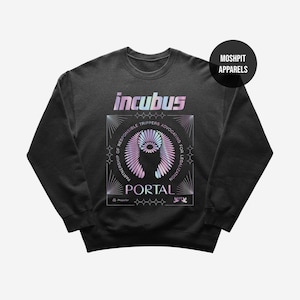 May include: A dark grey Incubus sweatshirt with a colourful, iridescent graphic. The design includes the band's name, the word "PORTAL," and text that reads "Partnership of Responsible Trippers Advocating for Legalization." A black circle with "Moshpit Apparels" is in the upper right.