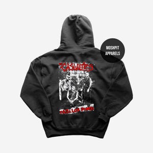 May include: Dark grey hooded sweatshirt with a graphic print of a band and the word "Zombies" in red. The text "Para Los Punks" is below the graphic in red. The sweatshirt has a round logo that says "Moshpit Apparels".